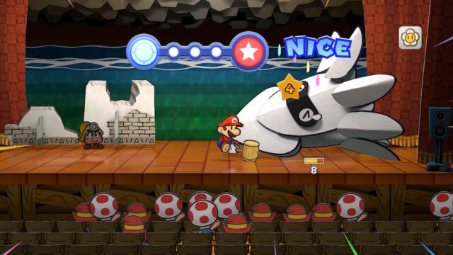 A screenshot of the game Paper Mario: The Thousand-Year Door. The screenshot shows Mario using his hammer on a Blooper and dealing four damage. The Blooper does not look happy to be getting hit.