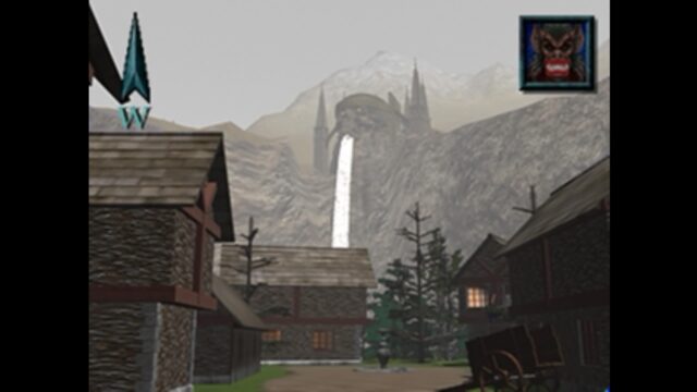 Screenshot from the game Blood Omen: Legacy of Kain. The screenshot looks like a still from an FMV cut scene. In it, you can see Kain's bat form in the top right. In the distance, a skull rock on a cliff face has water pouring out of it's mouth with castle towers behind it. Below, the perspective we're seeing is from someone inside a town with buildings around. 